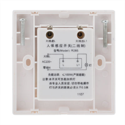 Backplate of white wall motion sensor switch with wiring terminals and screws
