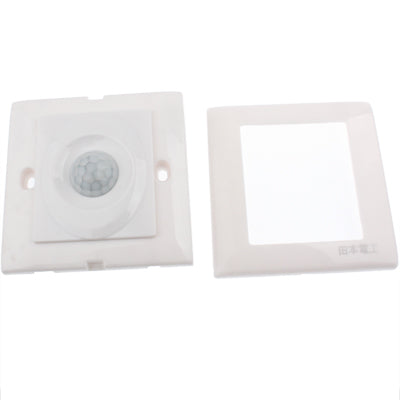 White PIR motion sensor switch face with circular lens, shown with open back