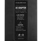 Black AC adapter label reading AC ADAPTER and input/output specifications