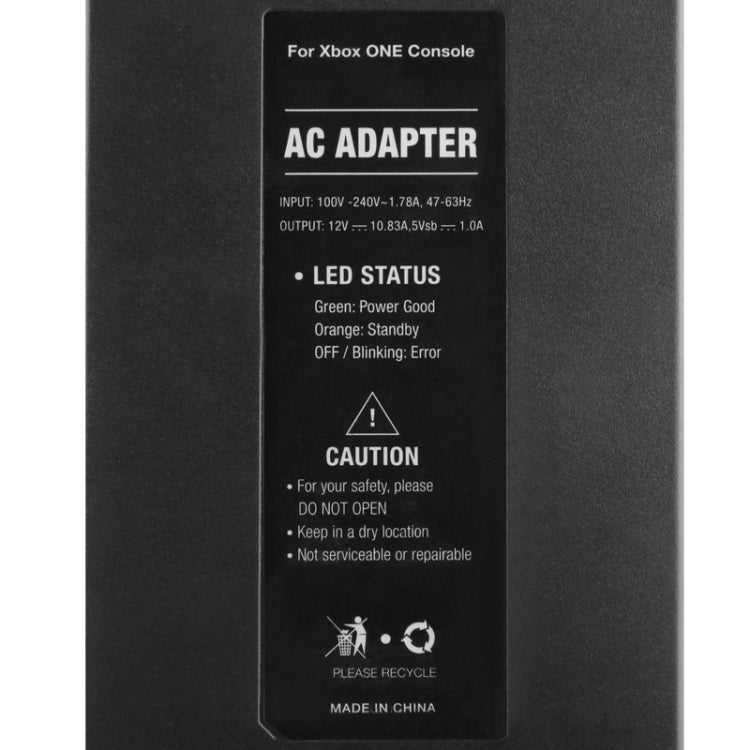 Black AC adapter label reading AC ADAPTER and input/output specifications