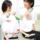 Portable electric massage stick with gray grip and round massage head, shown in use