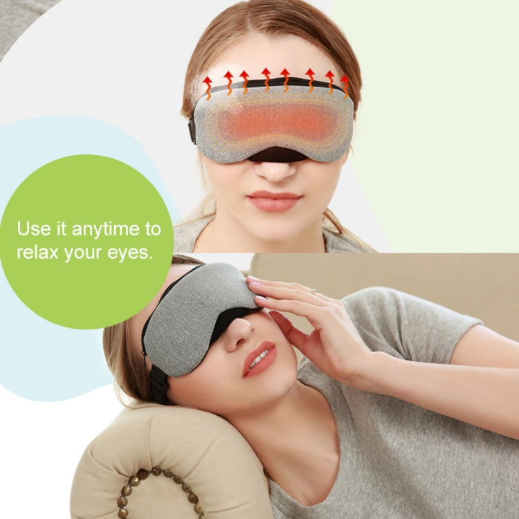 Grey heated sleep eye mask on a person’s face with warming airflow vents shown