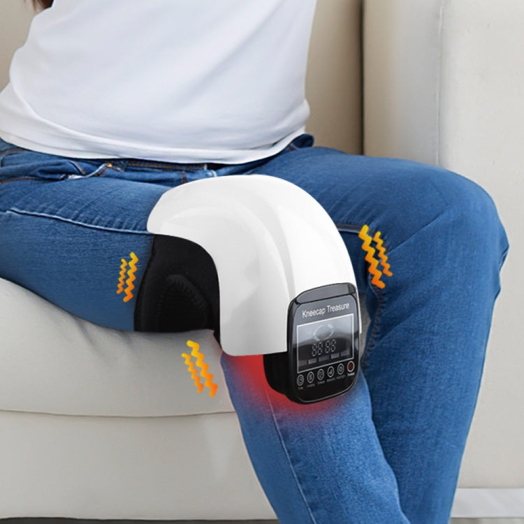 White knee heat massager placed on jeans leg with black control panel