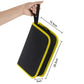 Compact soldering kit storage case held by a hand, with black body and yellow trim