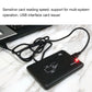 Black USB RFID card reader with connected cable and illuminated status LED