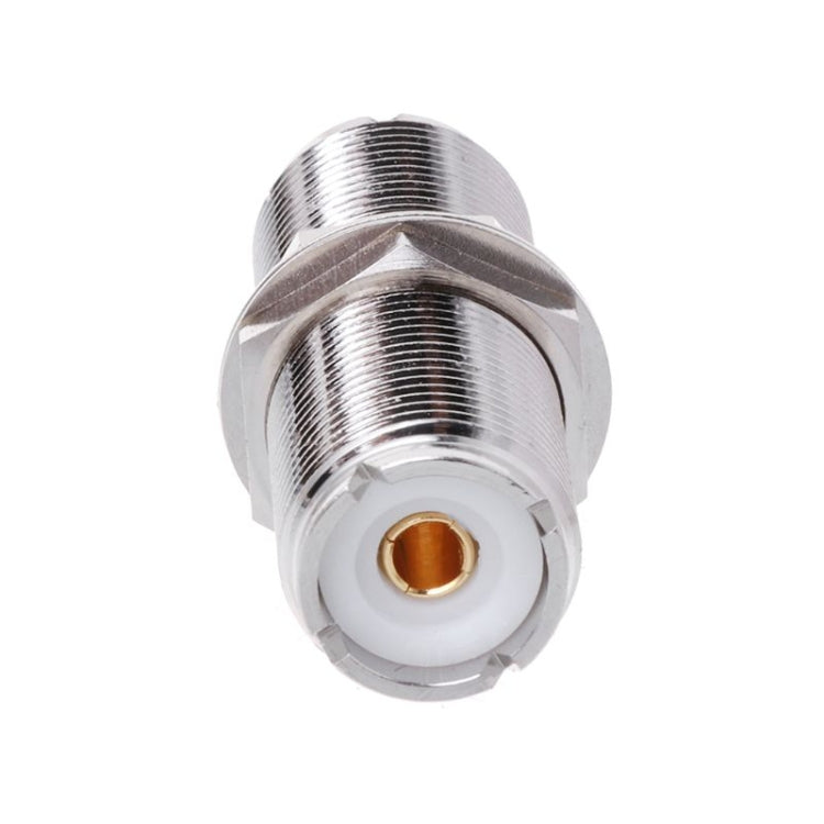 UHF female-to-female connector adapter, front view of gold center contact in white insert