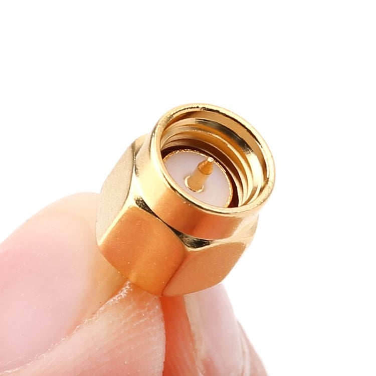 Gold connector adapter close-up, threaded SMA interior and center pin contact