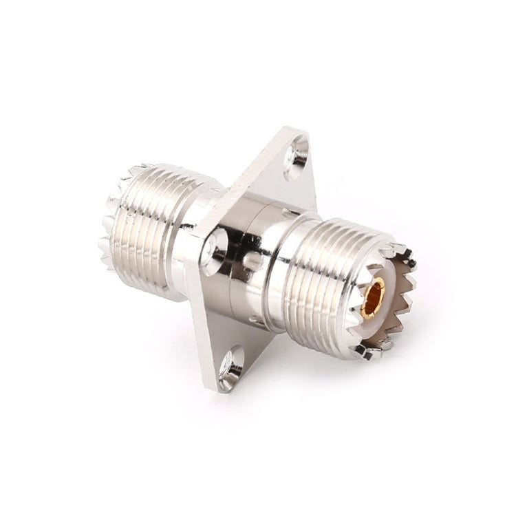 Angled view of panel-mount UHF SO-239 female-to-female RF adapter, silver metal, gold contact