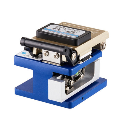 Optical fiber cleaver with blue base and beige body, black top handle and side screws