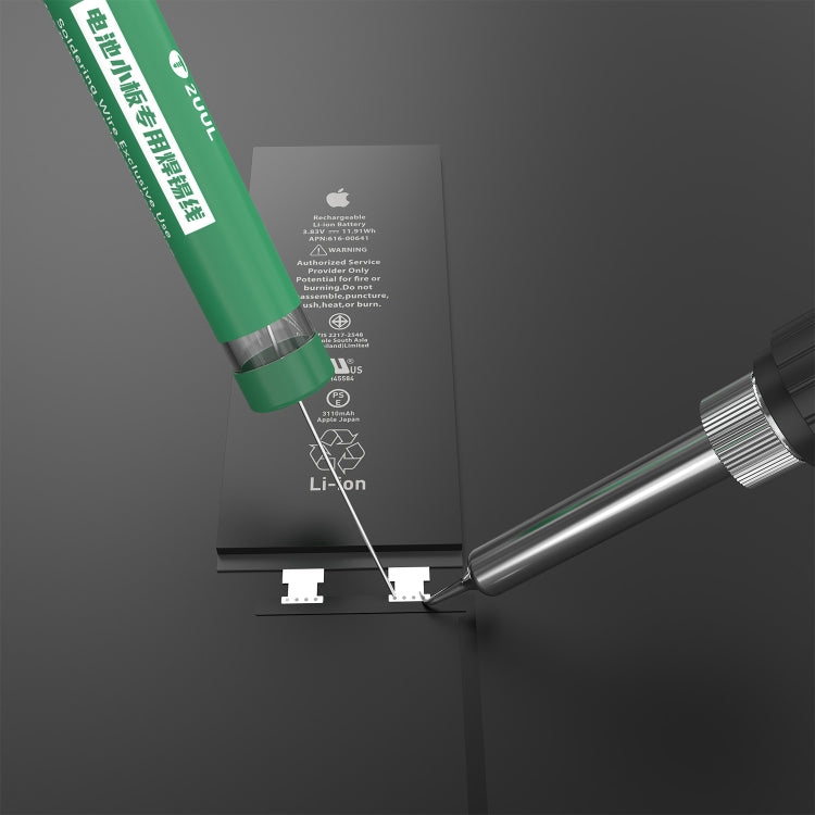 Green solder wire cartridge with solder tip near battery terminals