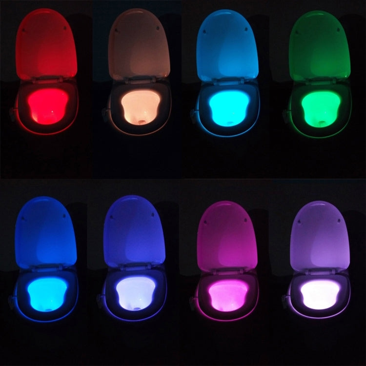 LED toilet nightlight showing different color glows across open toilet lid