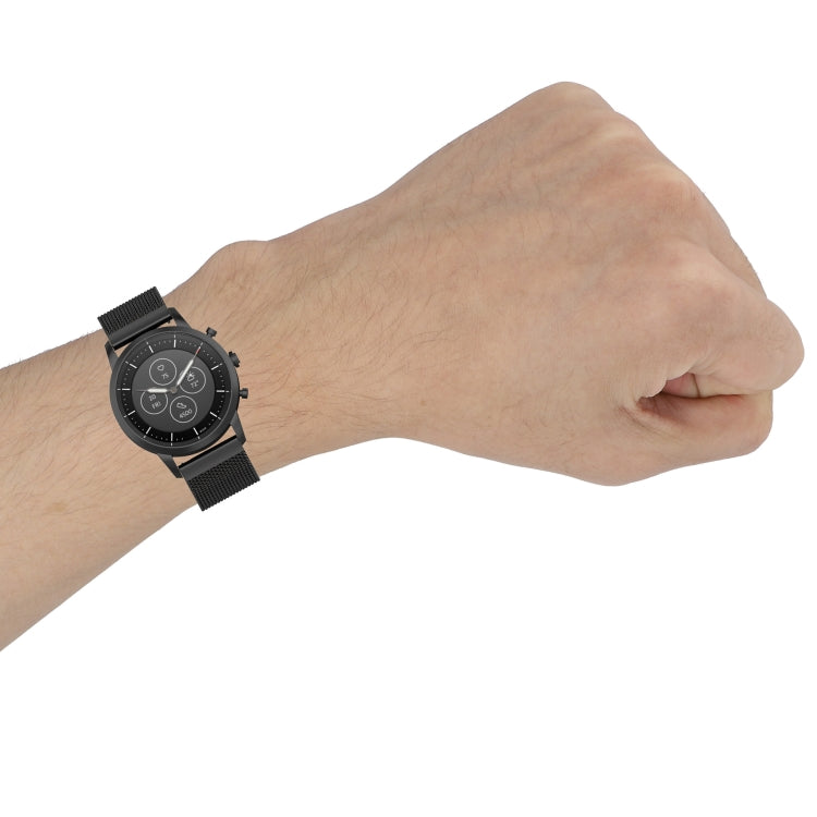 Black mesh watch strap worn on wrist with dark round watch face