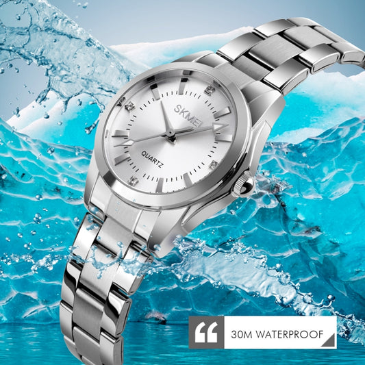 Silver-tone wristwatch with white dial, rhinestone markers, and metal bracelet