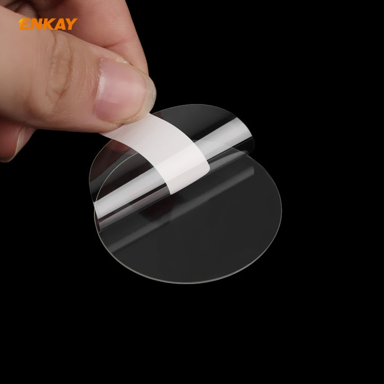 Close-up of curved tempered glass screen protector film being applied to a black watch