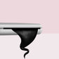 Hair curling iron close-up with dark hair on the curved plate