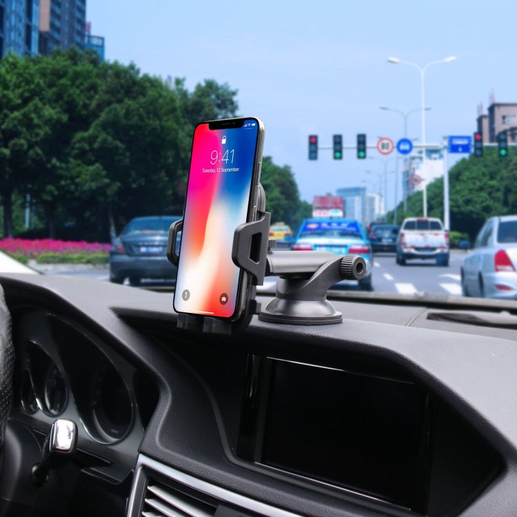 Car phone holder mounted on dashboard with suction cup base, holding a smartphone