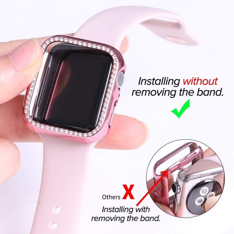 Pink Apple Watch case with rhinestone bezel being installed over a smartwatch screen
