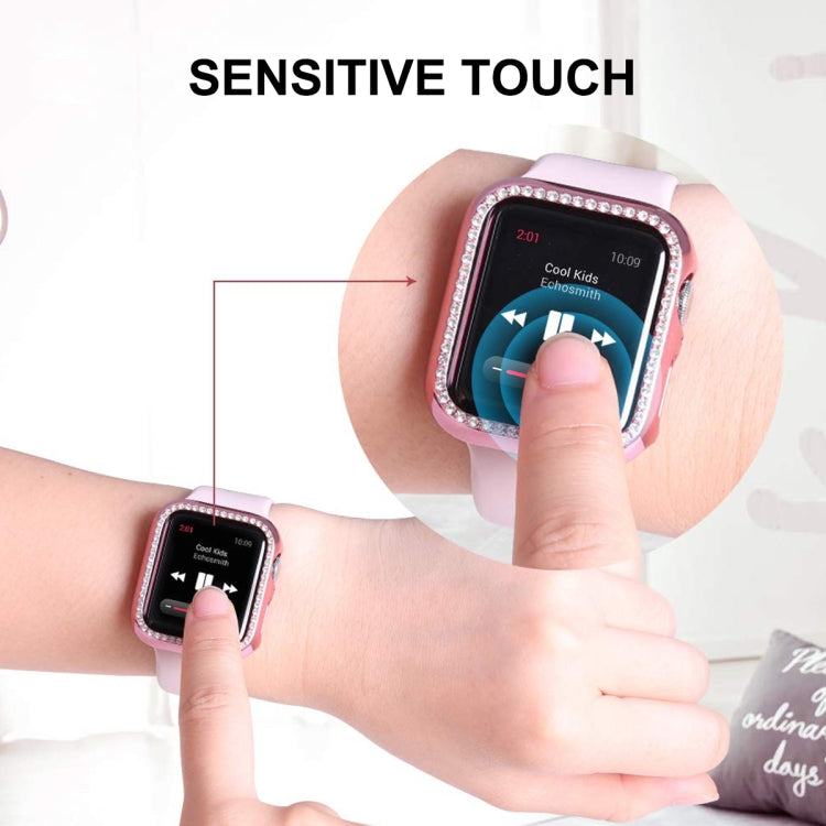 Pink Apple Watch case with clear screen protector; finger touching the protected display