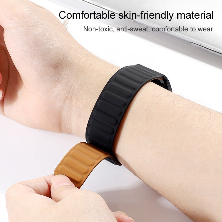 Silicone magnetic watch strap on wrist, black silicone band with brown underside, 42mm.