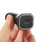 Black USB-C PD20W car charger close-up held in hand, textured front face visible