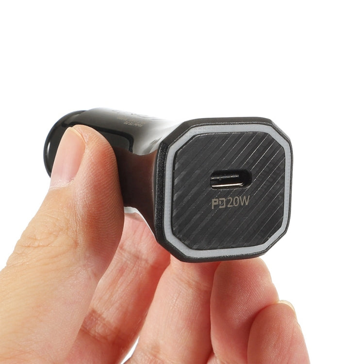 Black USB-C PD20W car charger close-up held in hand, textured front face visible