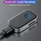 Bluetooth audio receiver with blue-ring button, dark metal body and AUX plug connected