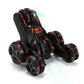 Black five-wheeled RC stunt car angled with green LED glow and orange accents