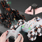 White and black RC stunt cars with remote controller, hands holding the gamepad
