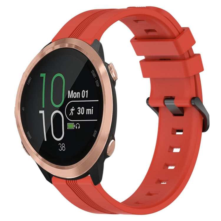 Orange silicone watch band with concave striped texture and buckle clasp, front view