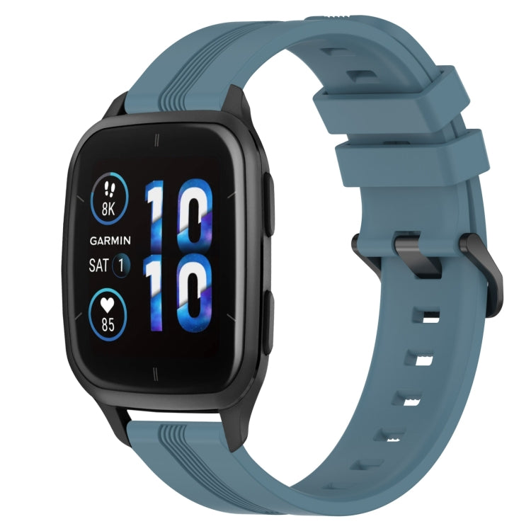 Concave striped silicone watch band in light blue with buckle, worn on a black smartwatch