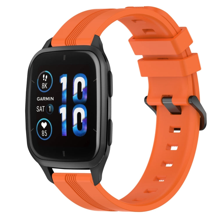 Concave striped silicone watch band in orange with buckle, worn on a black smartwatch