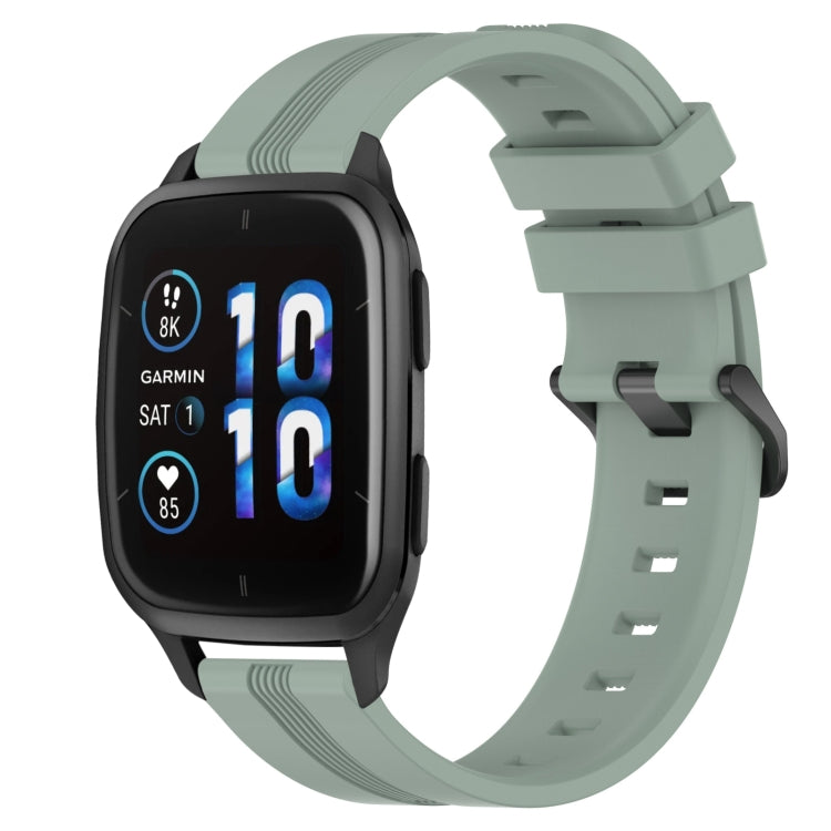 Concave striped silicone watch band in mint green with buckle, worn on a black smartwatch