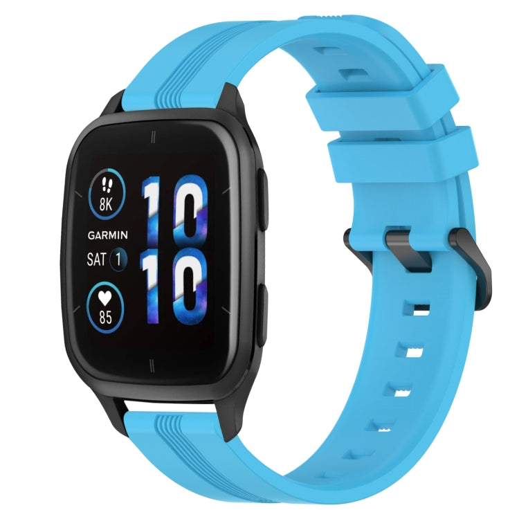 Concave striped silicone watch band in bright blue with buckle, worn on a black smartwatch