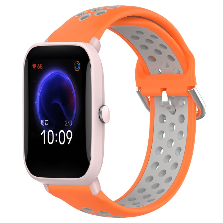 Perforated sports silicone watch band, orange with light gray underside, quick-snap clasp