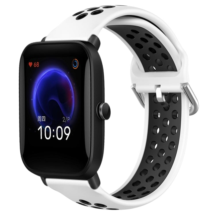 Perforated silicone sports watch band with white strap and black perforations, watch shown