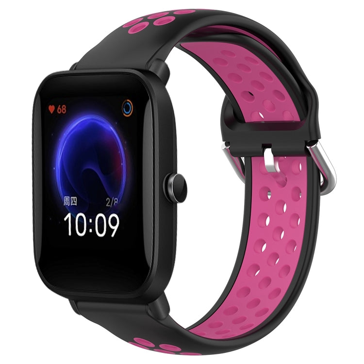 Perforated silicone sports watch band with black strap and bright pink perforations, watch shown