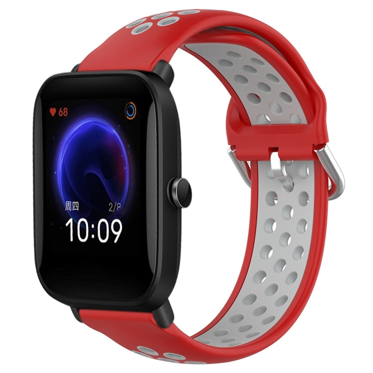 Perforated silicone sports watch band with red strap and gray perforations, watch shown