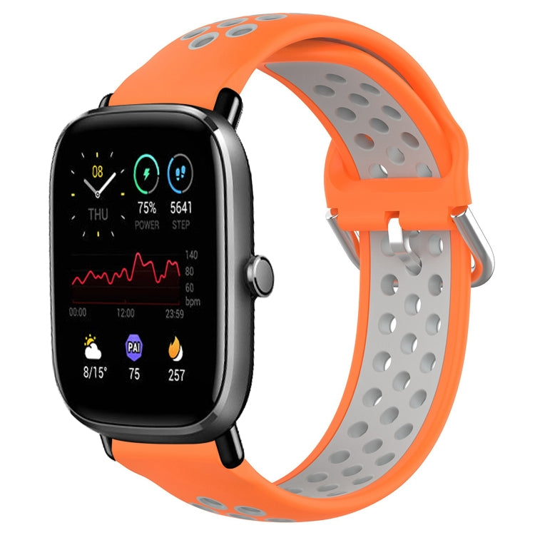 Perforated breathable silicone watch band with orange strap and gray perforations, smartwatch
