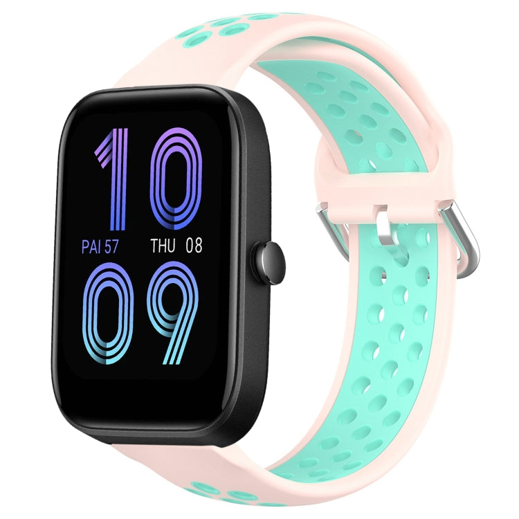 Light pink perforated silicone sports watch band with teal strap underside and metal buckle.