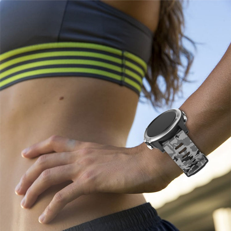 Gray camouflage silicone watch band on wrist with metal buckle