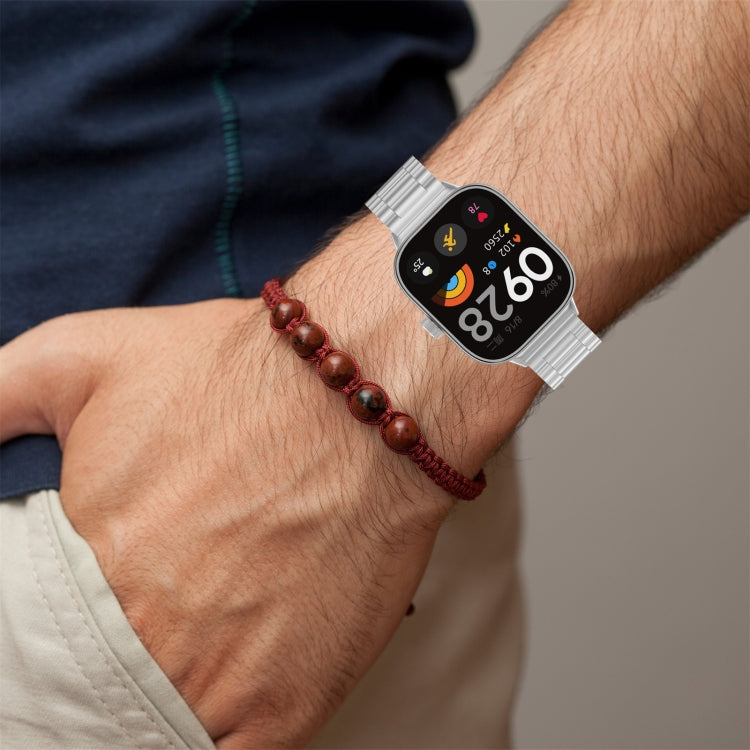 Silver metal watch band fitted to a smartwatch on a wrist