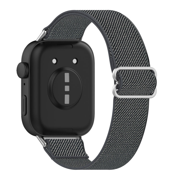 Back view of a dark gray elastic nylon watch band with metal loop and smartwatch.