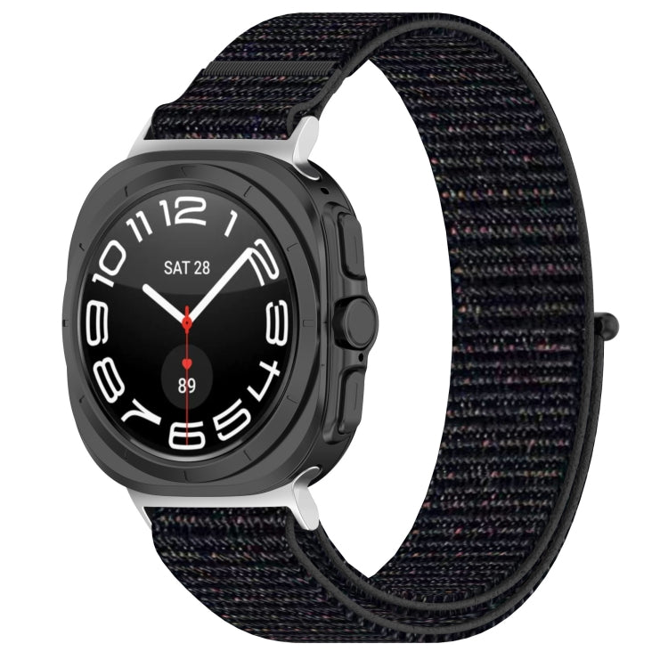 Galaxy Watch Ultra nylon loop band in black with subtle colored flecks, shown attached to watch