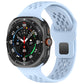 Sky blue perforated silicone watch band with square buckle, attached to a smartwatch