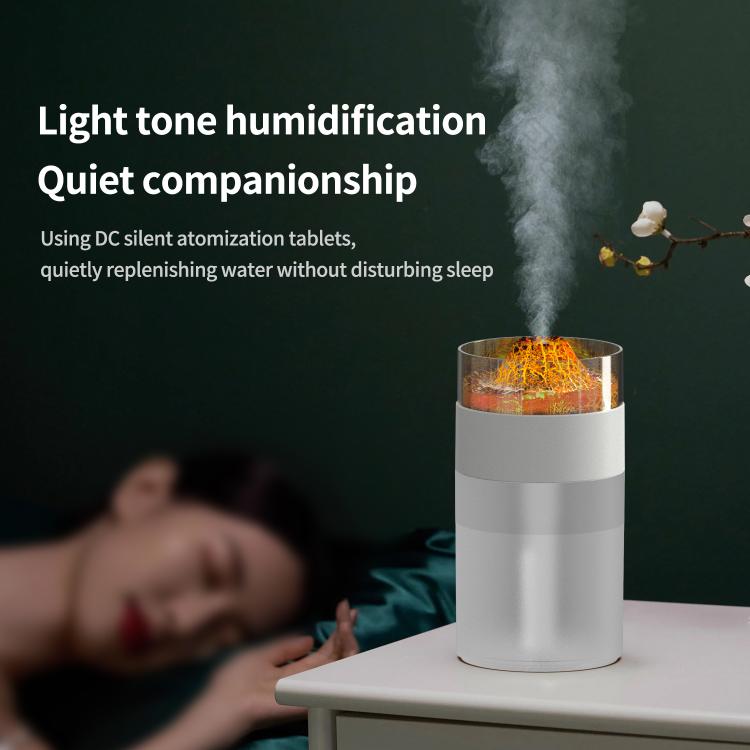 White simulated volcano humidifier with orange glow on bedside table, mist rising