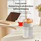 White simulated volcano humidifier with orange-lit top releasing mist near window seat