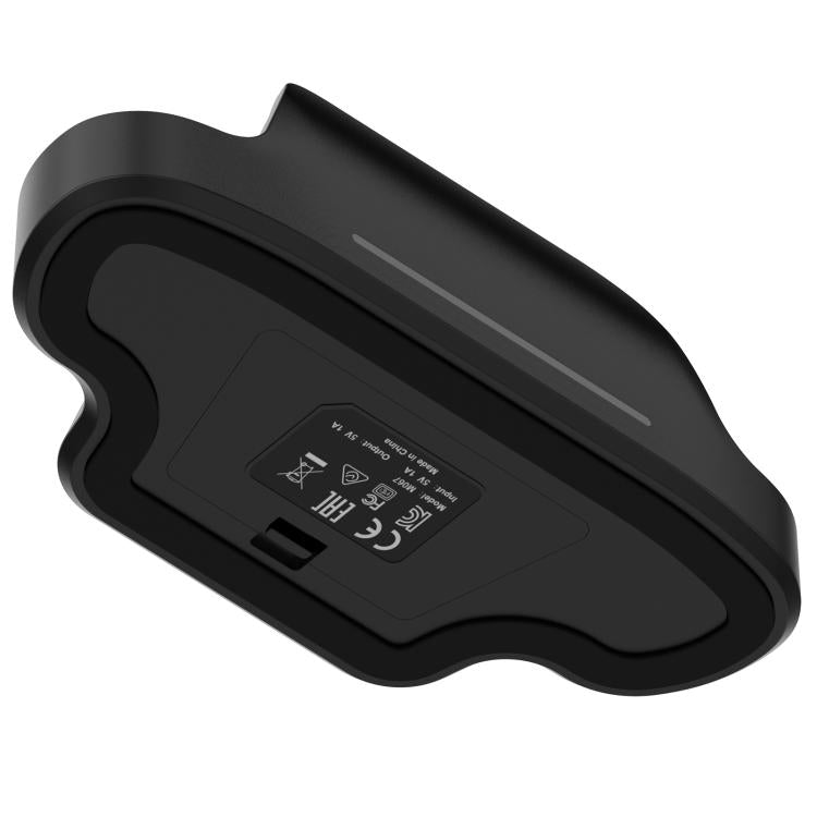 Black charging dock base underside with label panel and central charging area