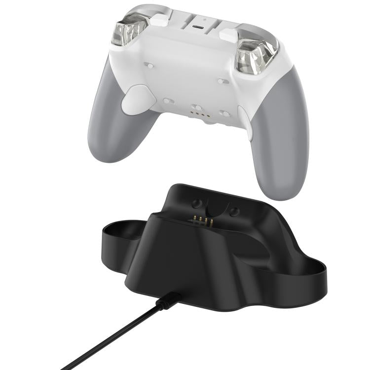 White game controller resting on black charging dock base with charging cable