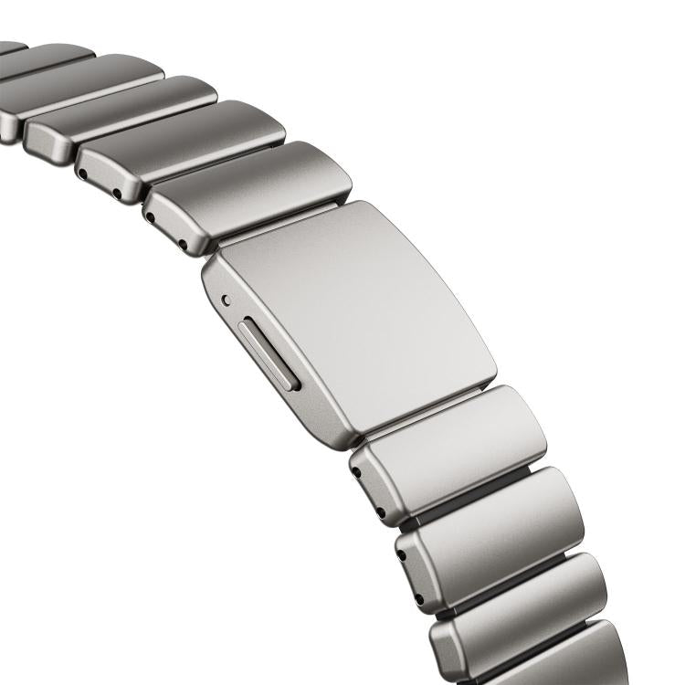 Close-up of the silver watch band's magnetic clasp and smooth metal links