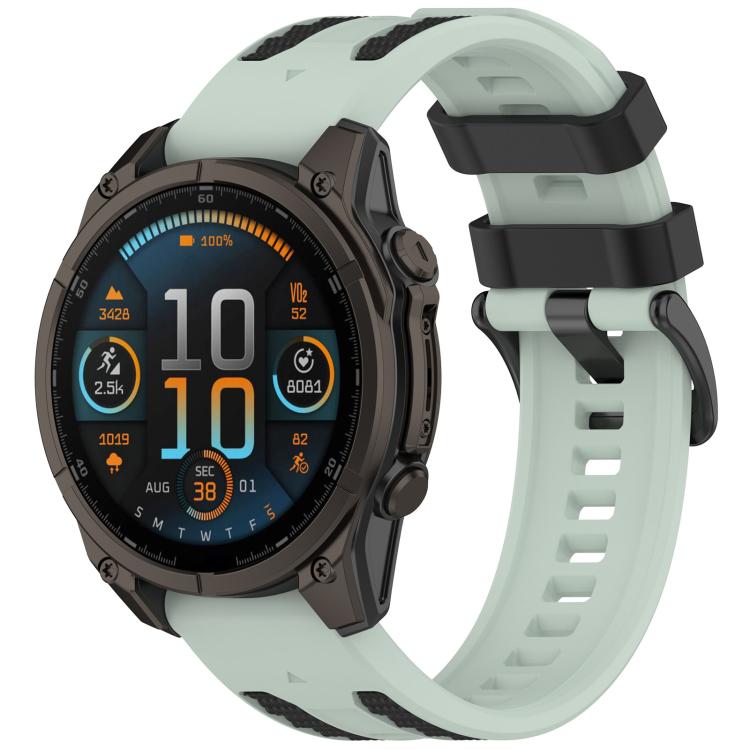 Garmin watch with a pale mint band, black keeper loops, and perforated strap.